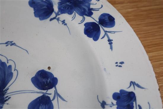 An 18th century Glasgow Delftware charger and a matching plate, largest 35.5cm